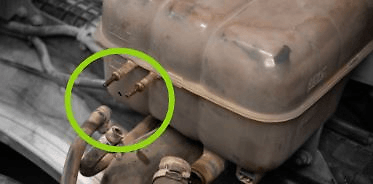 Disassemble all the attached hoses in the reservoir and the coolant level sensor connector.